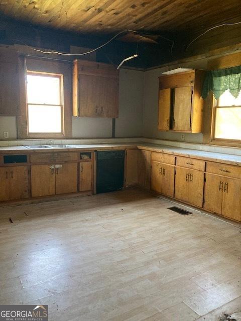 kitchen featuring a wealth of natural light, wooden ceiling, and light hardwood / wood-style flooring