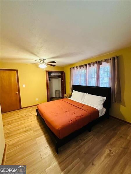 bedroom with ceiling fan and hardwood / wood-style floors