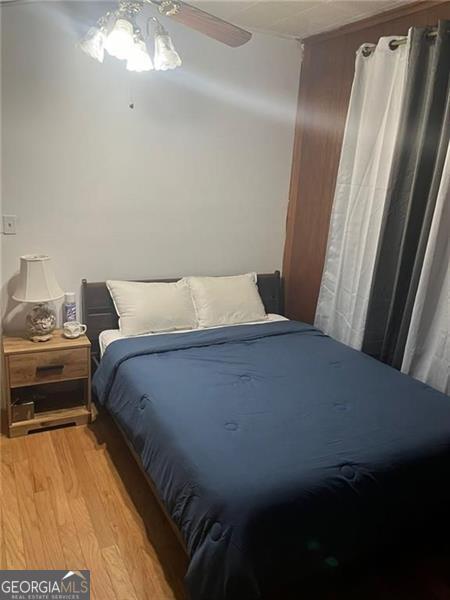 bedroom with light hardwood / wood-style floors and ceiling fan