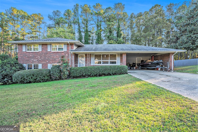 tri-level home with a front lawn and a carport