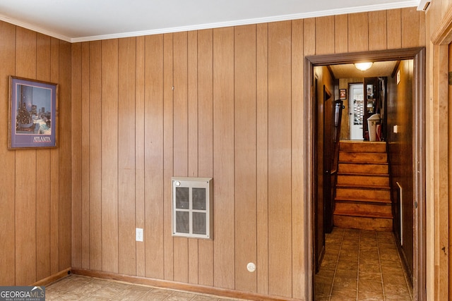 interior space featuring wooden walls, crown molding, and heating unit