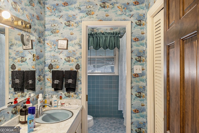 bathroom featuring vanity, tile patterned floors, and toilet