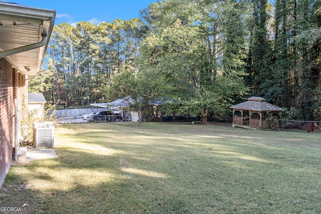 view of yard with central air condition unit and a gazebo