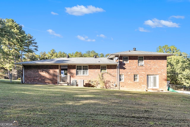 rear view of house featuring a yard