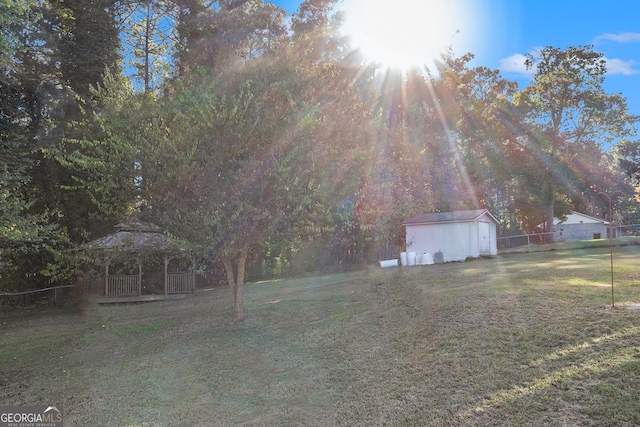 view of yard with a gazebo and a storage unit