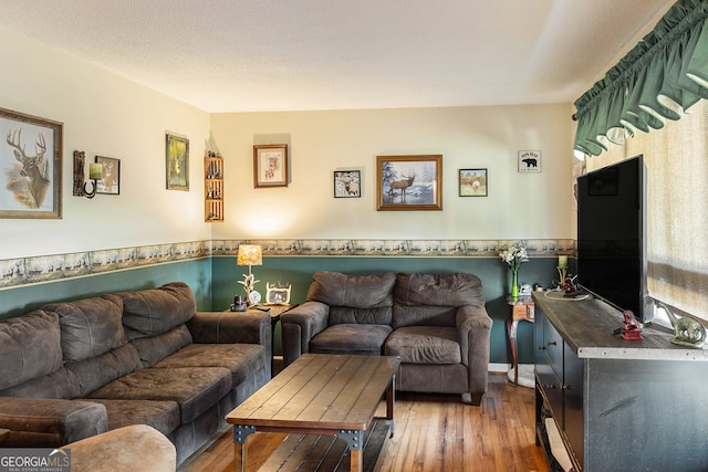 living room featuring a textured ceiling and hardwood / wood-style flooring