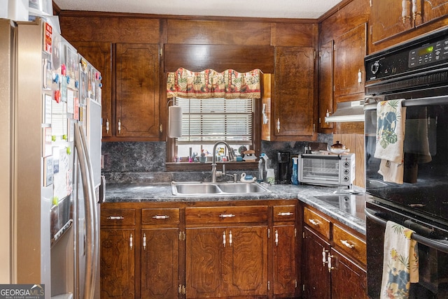 kitchen featuring black double oven, sink, tasteful backsplash, and stainless steel refrigerator with ice dispenser