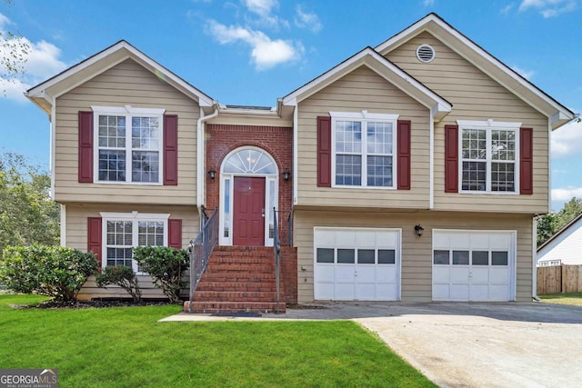 raised ranch with a garage and a front lawn