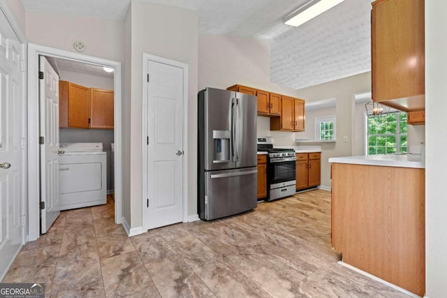 kitchen with a textured ceiling, lofted ceiling, and stainless steel appliances