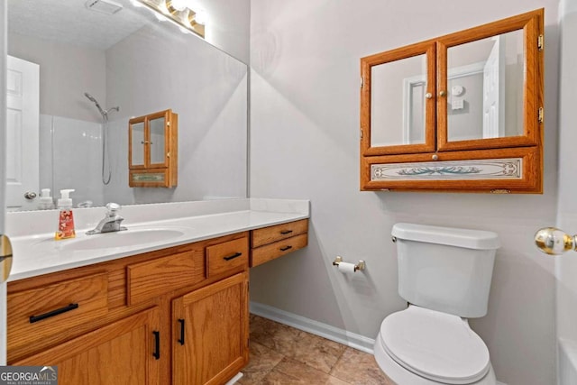 bathroom featuring a shower, vanity, a textured ceiling, tile patterned flooring, and toilet