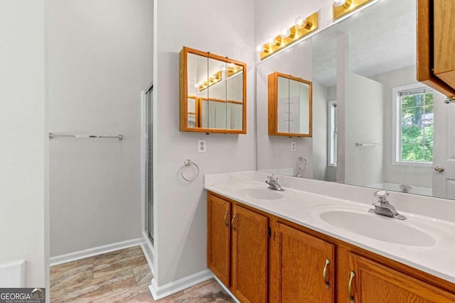 bathroom featuring vanity and a shower with door