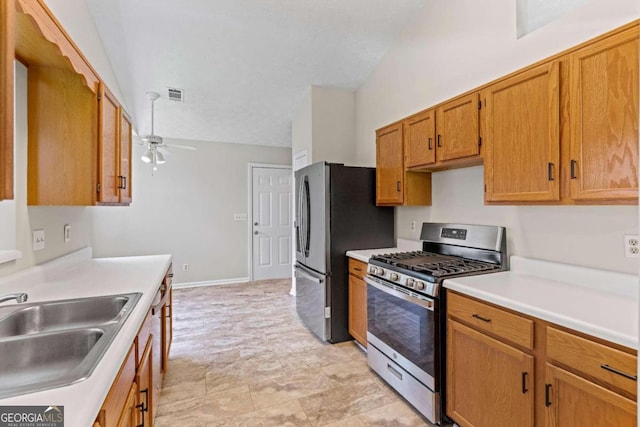 kitchen featuring lofted ceiling, ceiling fan, appliances with stainless steel finishes, and sink