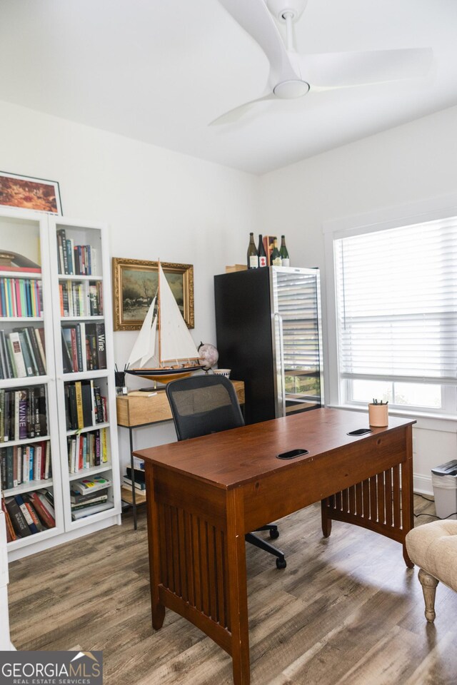 office area with hardwood / wood-style floors and ceiling fan