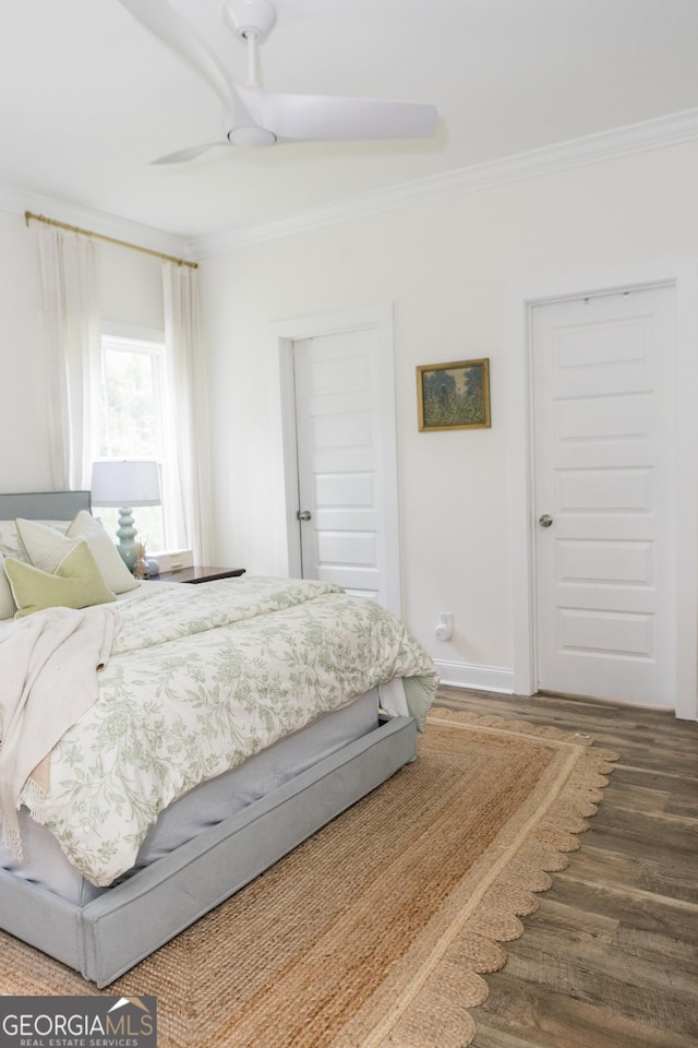 bedroom featuring hardwood / wood-style flooring, ornamental molding, and ceiling fan