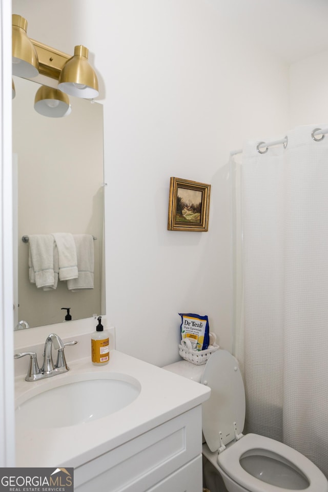 bathroom featuring vanity and toilet