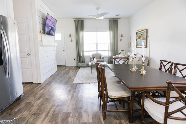 dining area featuring ceiling fan and dark hardwood / wood-style flooring