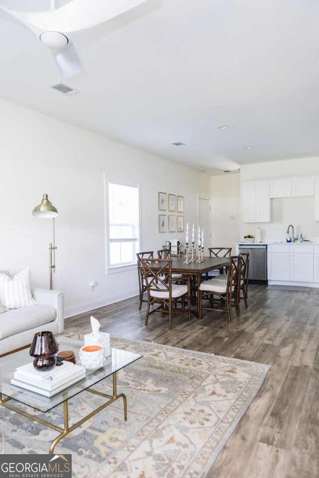 living room featuring wood-type flooring and sink