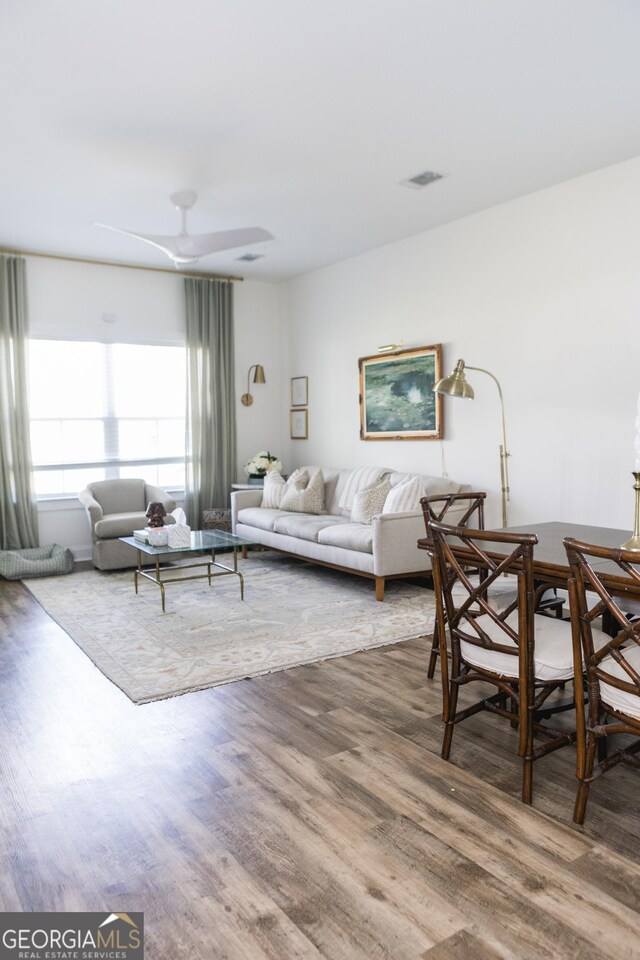 living room with ceiling fan and hardwood / wood-style floors