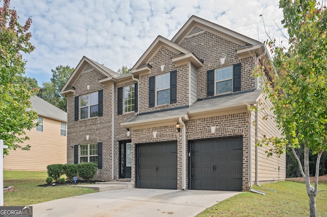 view of front facade with a front yard and a garage