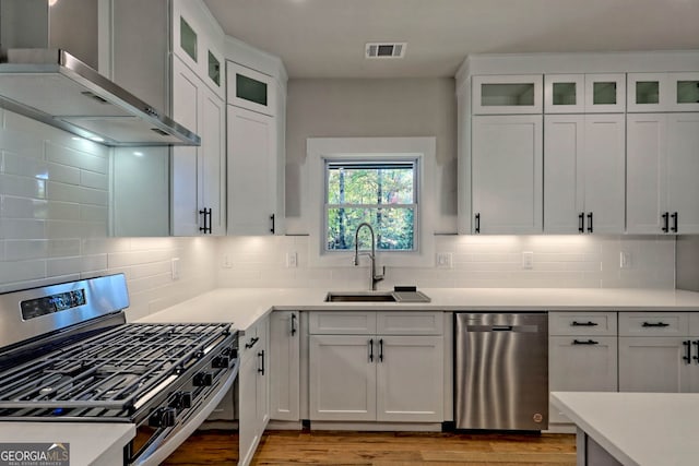 kitchen featuring stainless steel appliances and white cabinetry