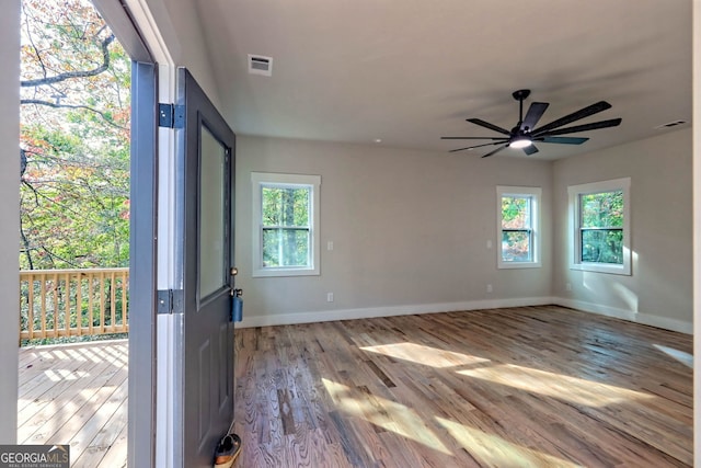 unfurnished room with ceiling fan and light hardwood / wood-style floors