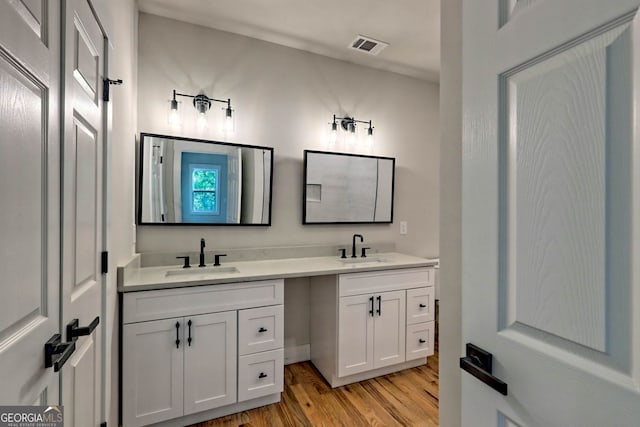 bathroom featuring hardwood / wood-style floors and vanity