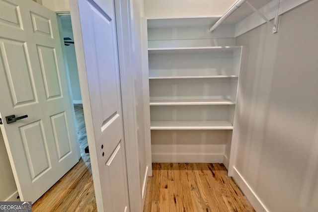 spacious closet with light hardwood / wood-style floors