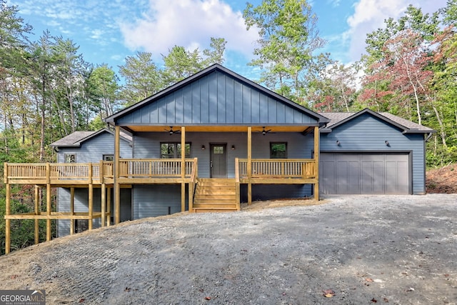 view of front of house featuring ceiling fan, a garage, and a wooden deck