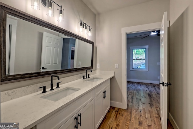 bathroom with hardwood / wood-style flooring, vanity, and ceiling fan