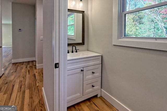 bathroom featuring a wealth of natural light, vanity, and hardwood / wood-style flooring