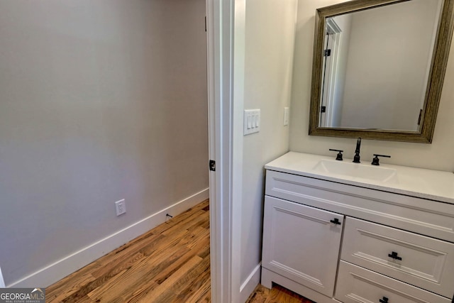 bathroom with hardwood / wood-style flooring and vanity