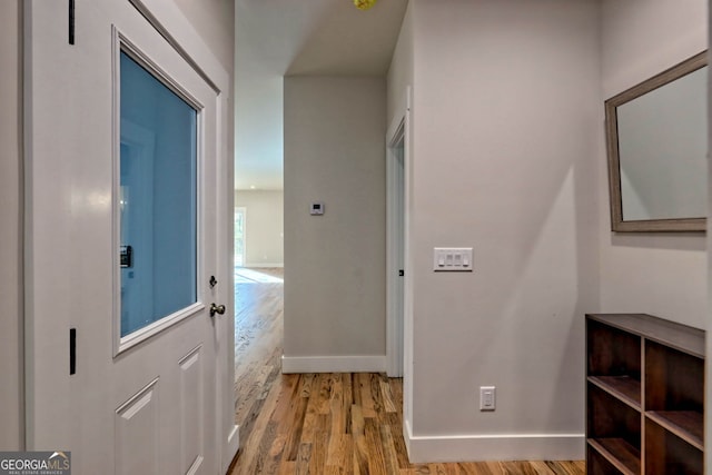 corridor with light hardwood / wood-style floors