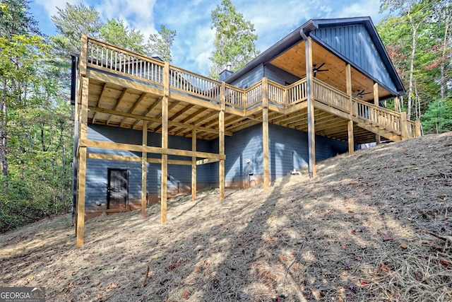 rear view of house featuring ceiling fan and a deck