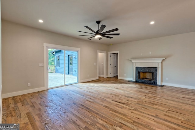 unfurnished living room featuring ceiling fan and light hardwood / wood-style floors