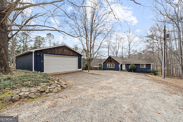 view of front of property with a garage and an outdoor structure