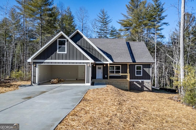 view of front of house featuring an attached garage, board and batten siding, driveway, and a shingled roof