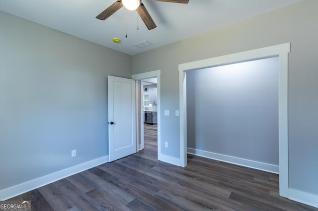 unfurnished bedroom featuring dark wood-type flooring and ceiling fan