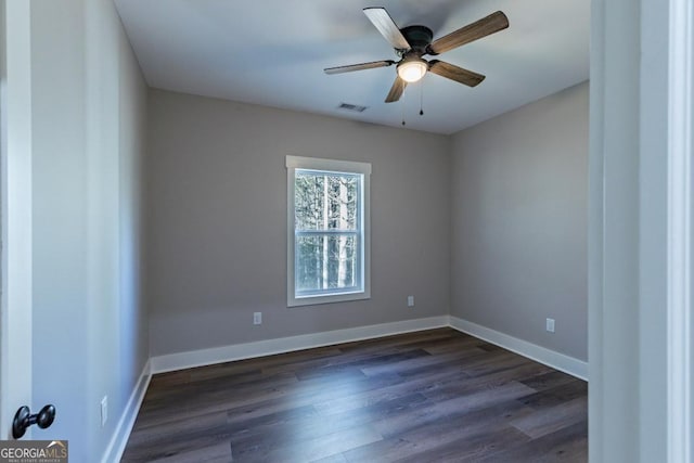 empty room featuring ceiling fan and dark hardwood / wood-style flooring