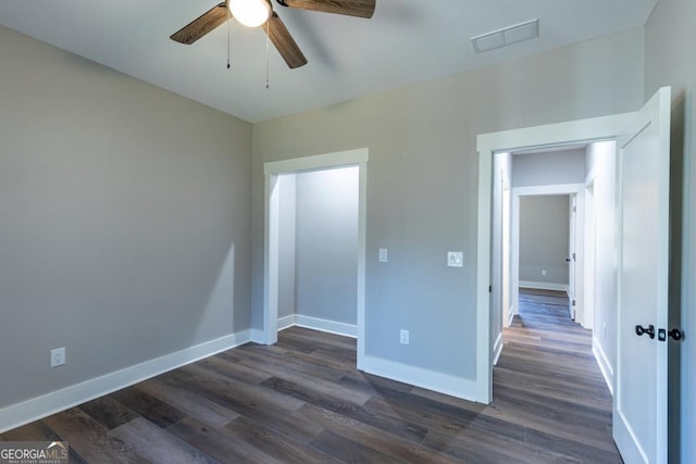 unfurnished bedroom with dark hardwood / wood-style flooring and ceiling fan