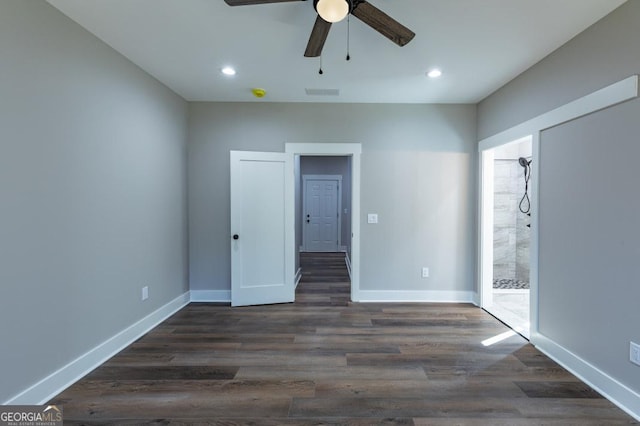 spare room with ceiling fan and dark hardwood / wood-style flooring