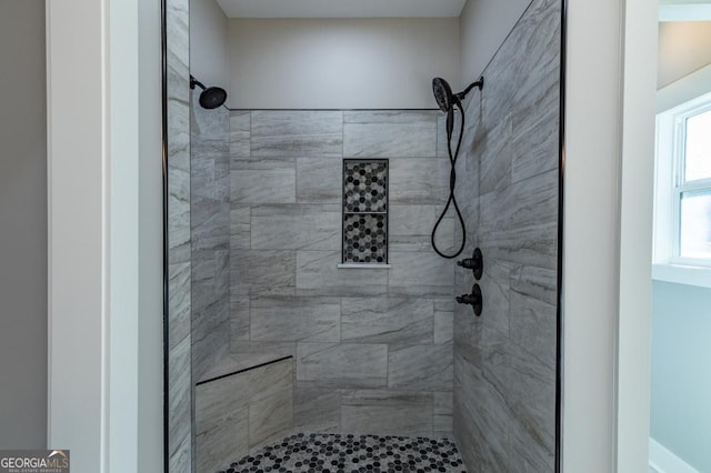 bathroom with a tile shower