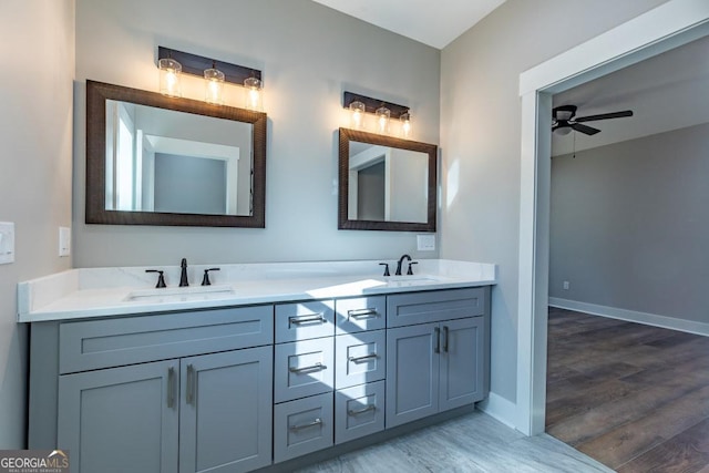 bathroom featuring hardwood / wood-style flooring, vanity, and ceiling fan