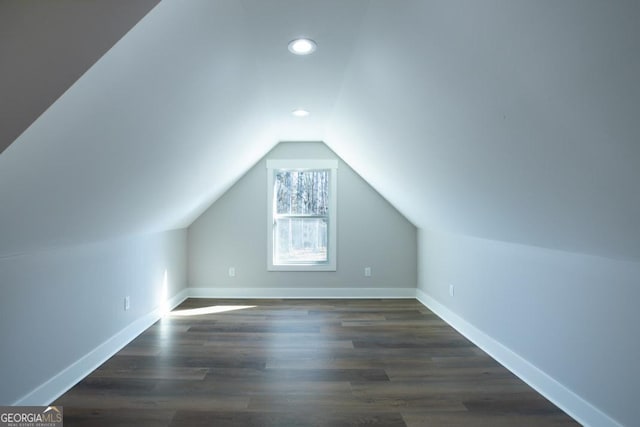 bonus room featuring dark hardwood / wood-style flooring and vaulted ceiling