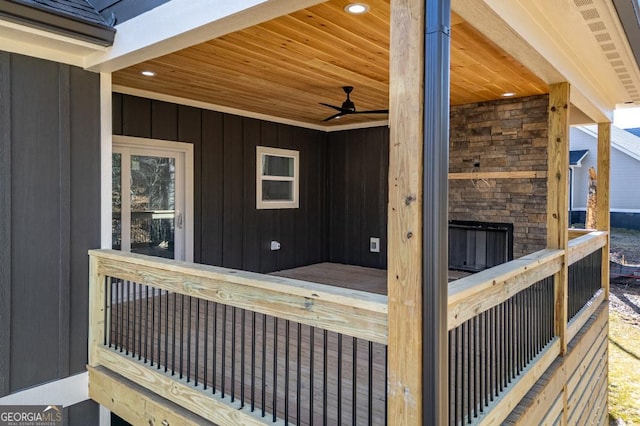 wooden deck featuring ceiling fan