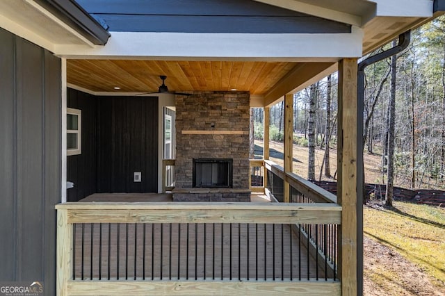 exterior space featuring ceiling fan and an outdoor stone fireplace