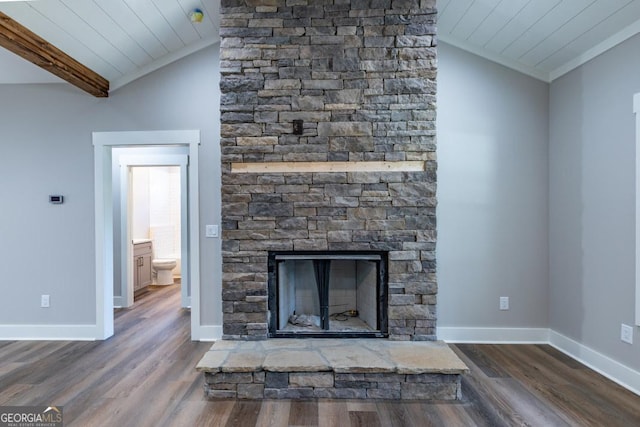 interior details featuring a stone fireplace, wood-type flooring, and ornamental molding