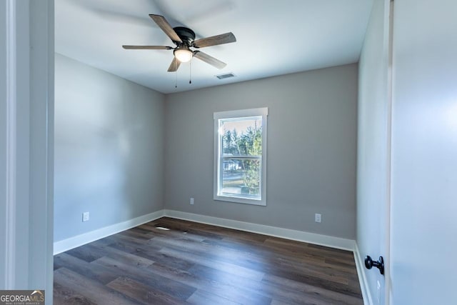 empty room with dark wood-type flooring and ceiling fan