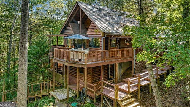 rear view of house featuring a deck