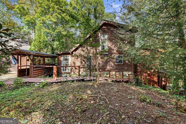 back of house featuring a deck