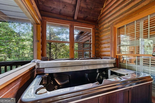 interior space featuring rustic walls and wooden ceiling